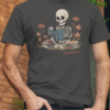 Skeleton reading a blue book surrounded by flowers and stacked books with “#myafterlife” text printed on an asphalt grey t-shirt | Smolt