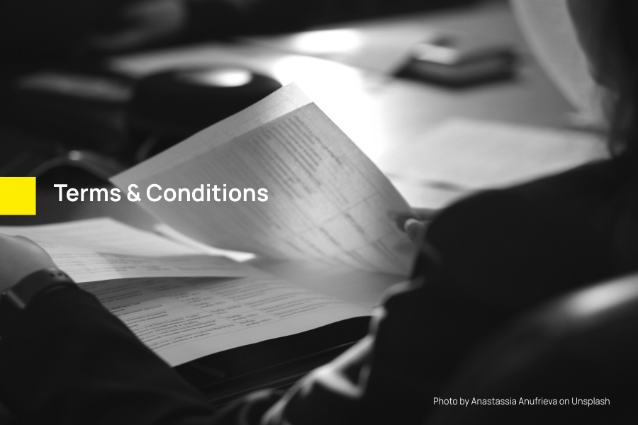 Close up of a man reading through documents depicting Terms & Conditions | Smolt