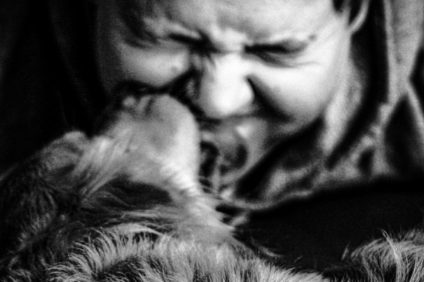 A man petting his dog | What's your ism | Smolt
