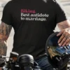 “Biking. Best antidote to marriage.” typography graphic printed in pink and white on a black t-shirt worn by a biker sitting on a motorcycle | Smolt