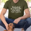 “Begging is a human vocation. Not a pet’s.” typography graphic printed in white on an olive green t-shirt with a dachshund dog | Smolt