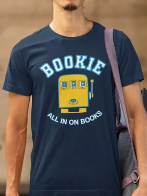 “Bookie – All In On Books” graphic with a yellow slot machine illustration printed on a navy blue t-shirt | Smolt