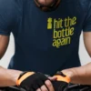“hit the bottle again” typography graphic with a cycling water bottle illustration printed in yellow on a navy blue t-shirt | Smolt