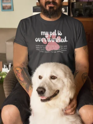 “My pet is overworked” typography graphic with humorous pet role descriptions printed on an asphalt grey t-shirt beside a white dog | Smolt