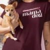 “mama dog” typography graphic with crossed-out “dog mama” text printed in white and pink on a maroon t-shirt | Smolt