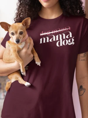 “mama dog” typography graphic with crossed-out “dog mama” text printed in white and pink on a maroon t-shirt | Smolt