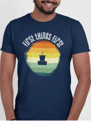 “First Things First” retro sunrise graphic with a filter coffee tumbler illustration printed on a navy blue t-shirt | Smolt