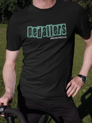 “Pedallers Anonymous” distressed typography graphic printed in teal and white on a black cycling t-shirt | Smolt