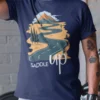 “Saddle Up” scenic winding road and mountain graphic printed on a navy blue t-shirt | Smolt