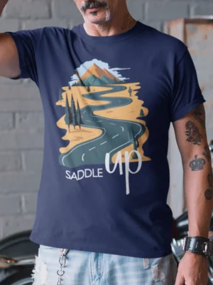 “Saddle Up” scenic winding road and mountain graphic printed on a navy blue t-shirt | Smolt