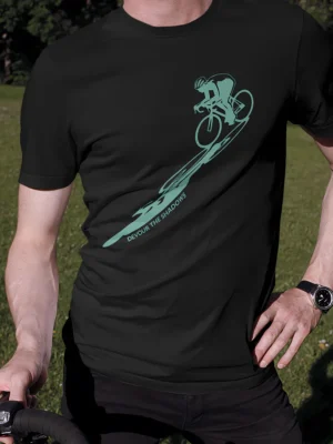 Minimal cyclist silhouette graphic with “Devour The Shadows” text printed in teal on a black cycling t-shirt | Smolt