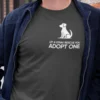 “Let A Stray Rescue You Adopt One” dog adoption typography graphic with minimal dog illustration printed in white on an asphalt grey t-shirt | Smolt